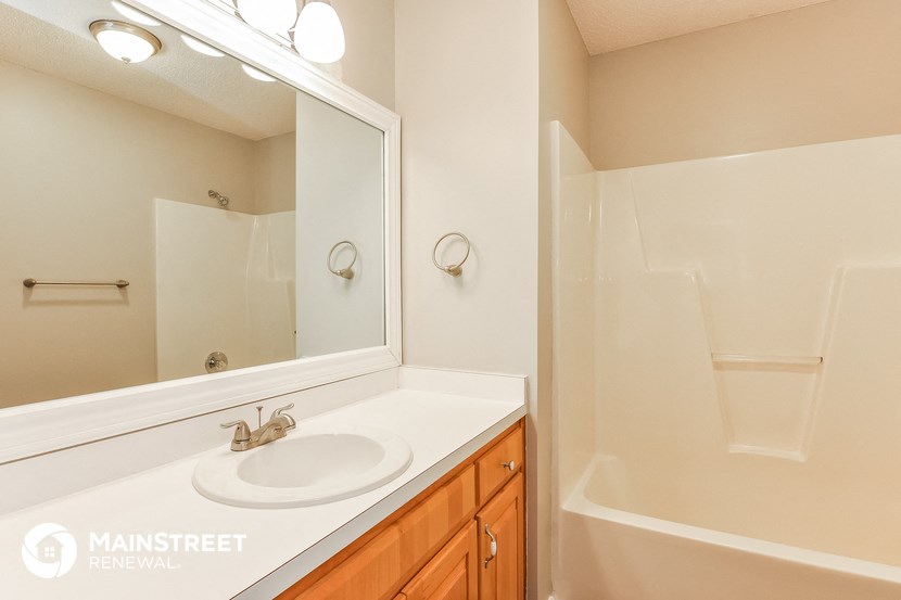 a bathroom with a sink and a mirror and a shower