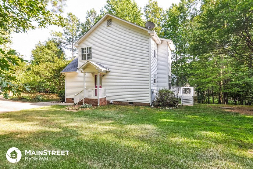 a white house with a yard in front of it