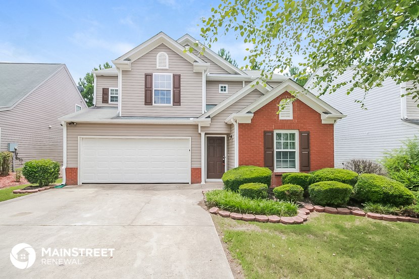 a white house with a driveway and a garage door
