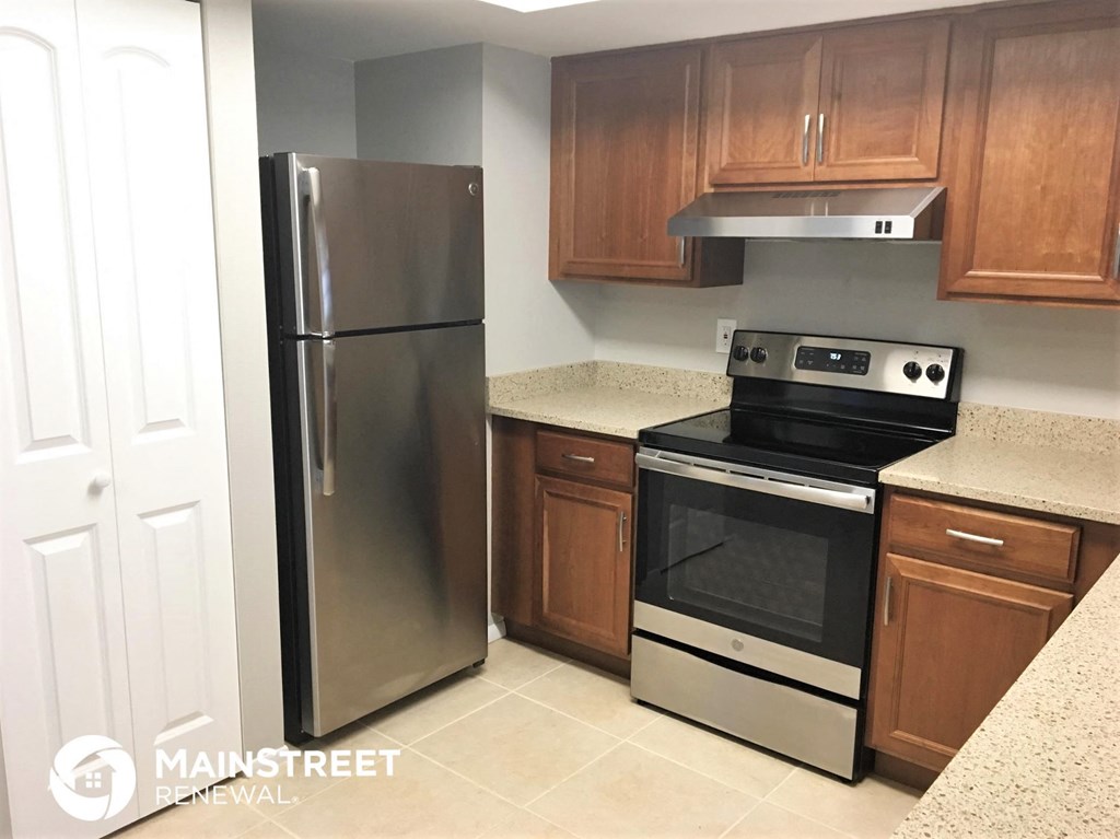 a kitchen with stainless steel appliances and wooden cabinets