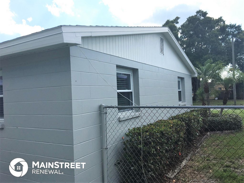 a small house with a fence in front of it
