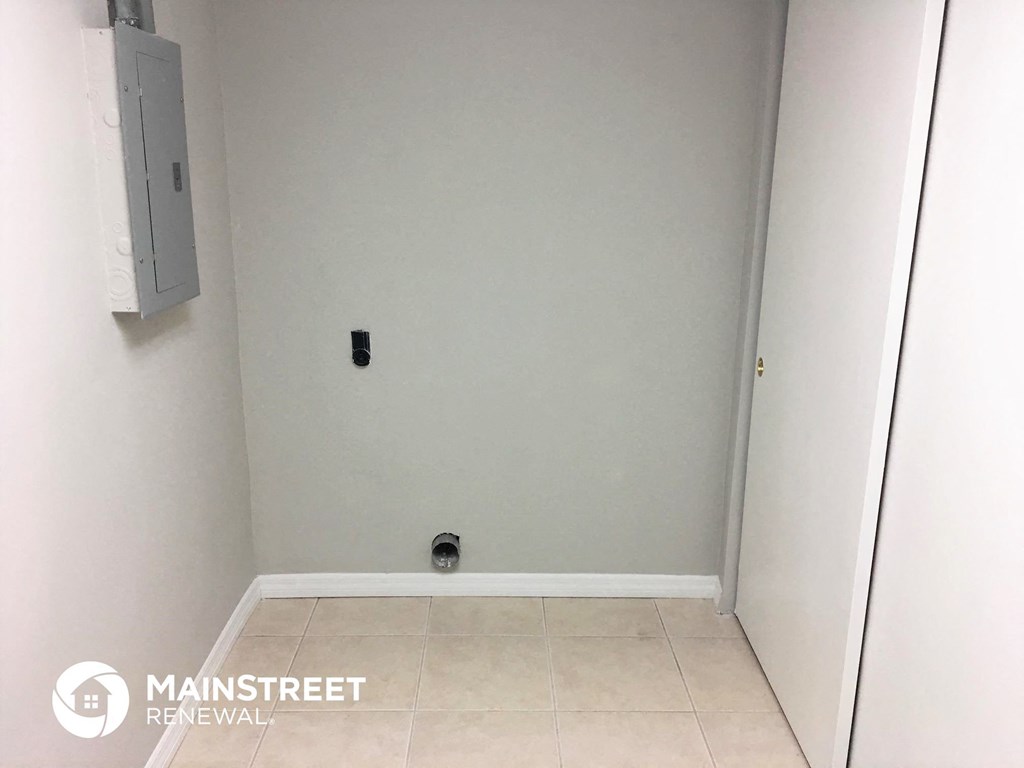 an empty room with a white wall and a white door