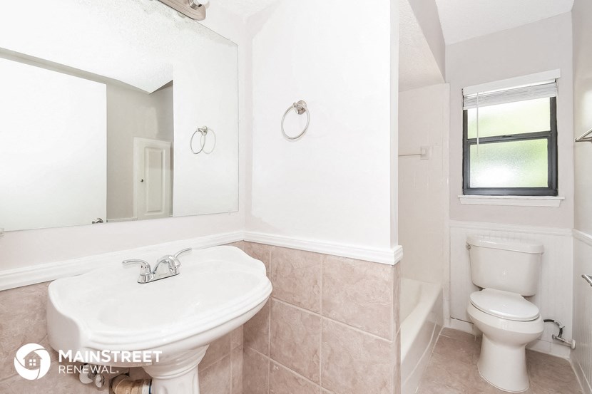 a bathroom with a sink and a toilet and a mirror
