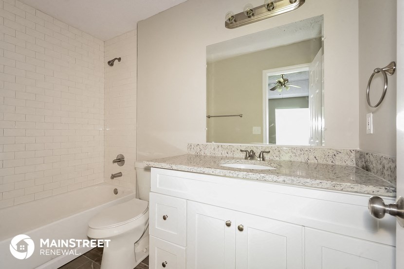 a bathroom with a sink and a toilet and a mirror