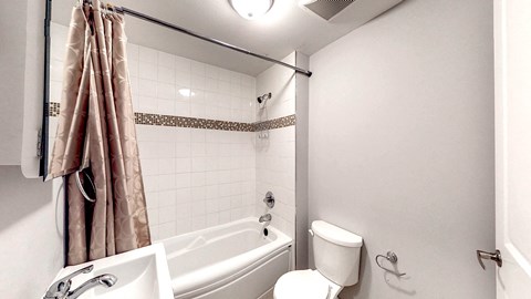 a bathroom with a tub and a toilet and a sink