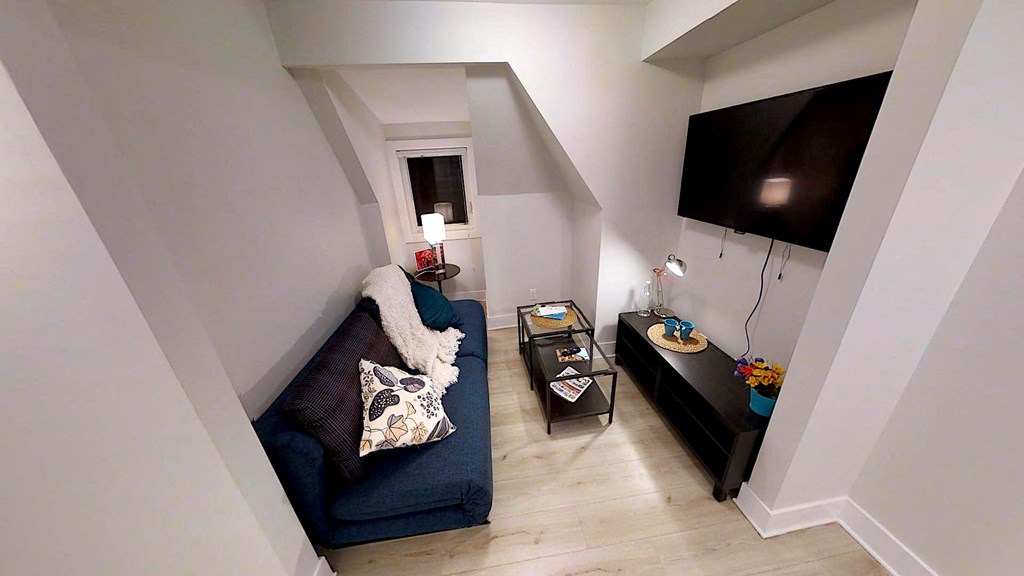 a small living room with a couch and a tv
