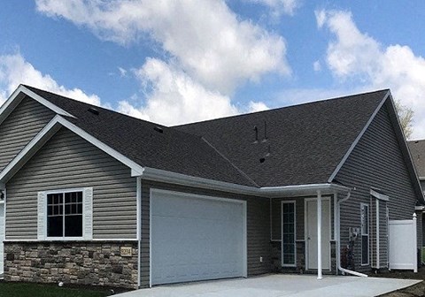 a gray house with a white garage door