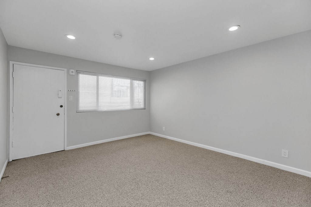 an empty room with a door and a window