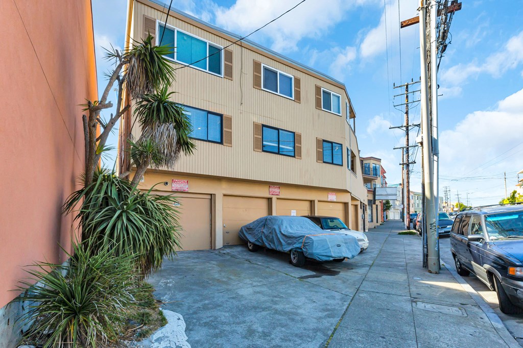 an apartment building with a car parked in front of it
