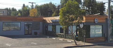a small building with a tree in front of it