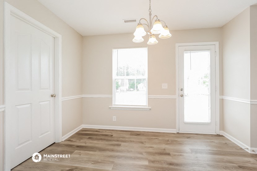 an empty room with a door and a window