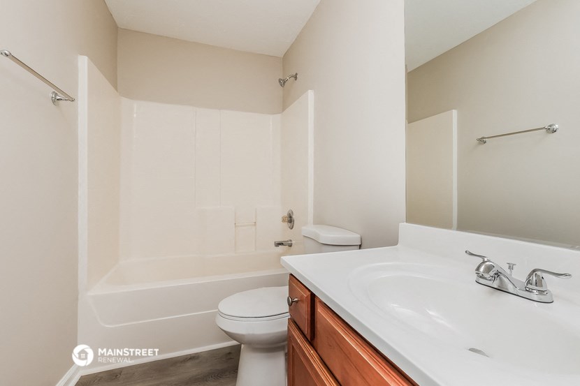 a bathroom with a sink and a toilet and a tub