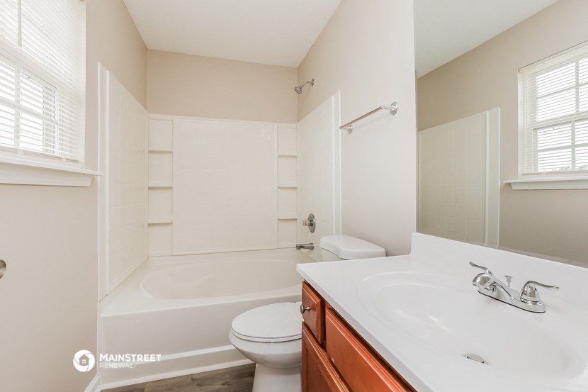 a bathroom with a sink and a toilet and a tub