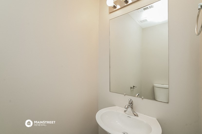 a small bathroom with a sink and a mirror