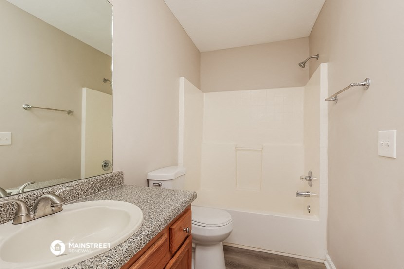 a bathroom with a sink toilet and a shower