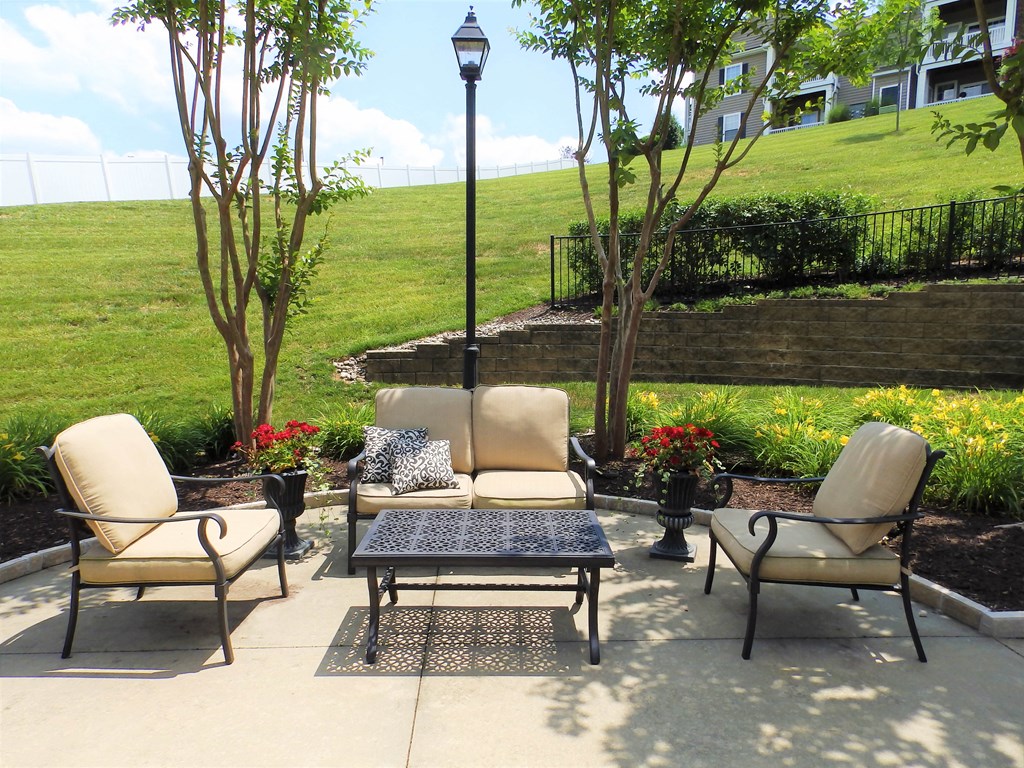 a patio with chairs and a table on a patio