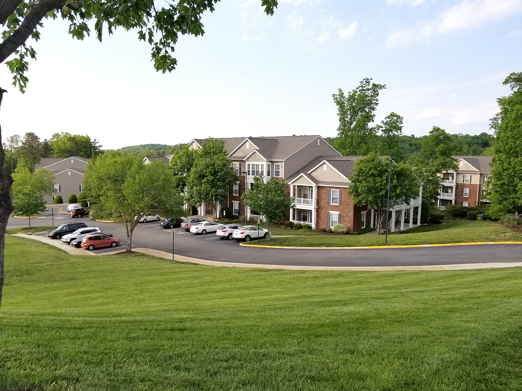 an aerial view of a neighborhood with cars parked in front of houses