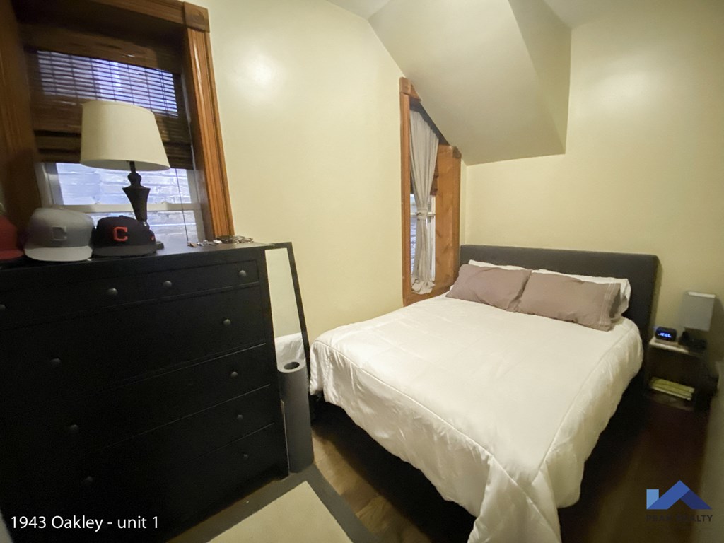 a bedroom with a bed and a dresser and a window