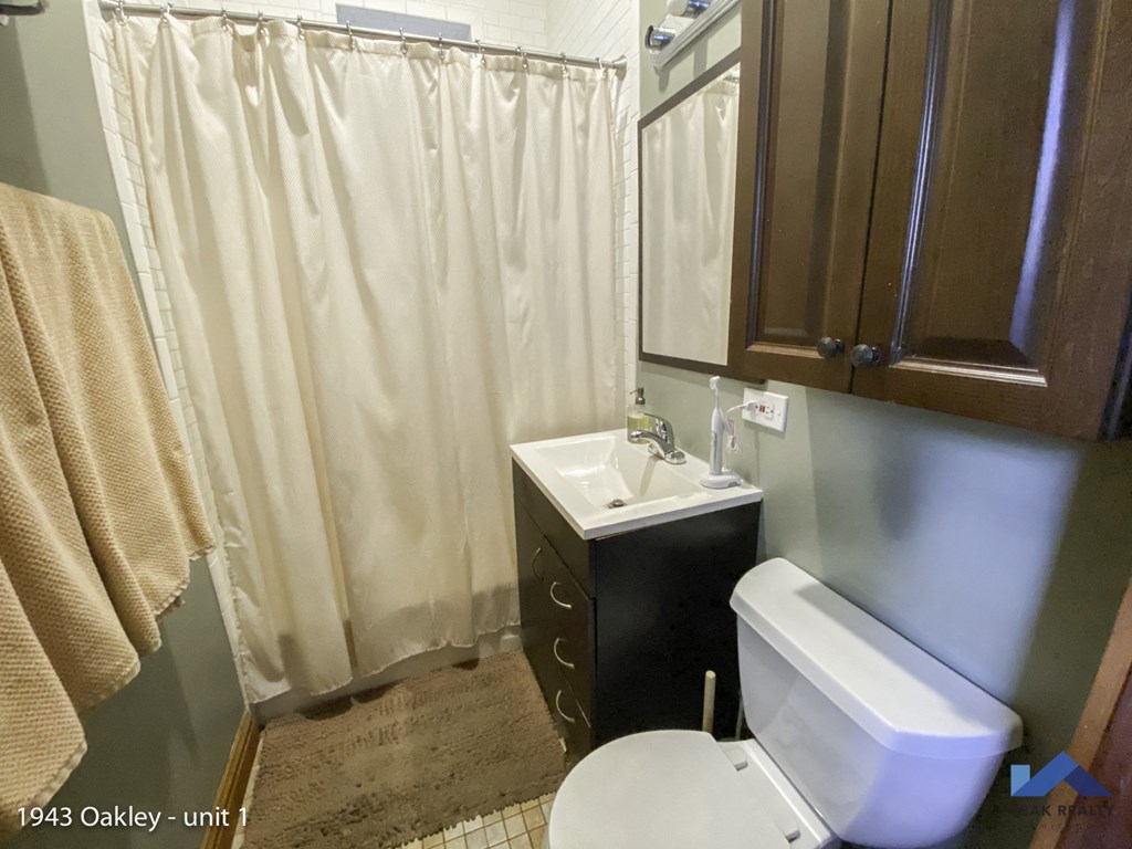 a bathroom with a white toilet and a sink