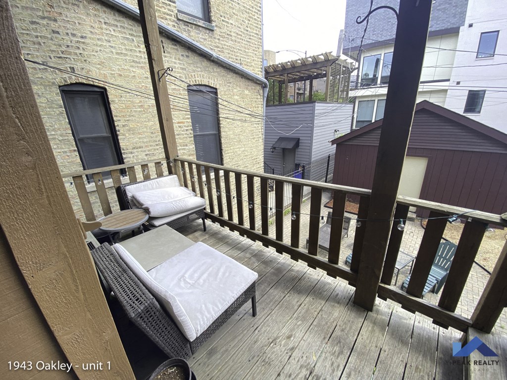 a balcony with two couches and a table on it