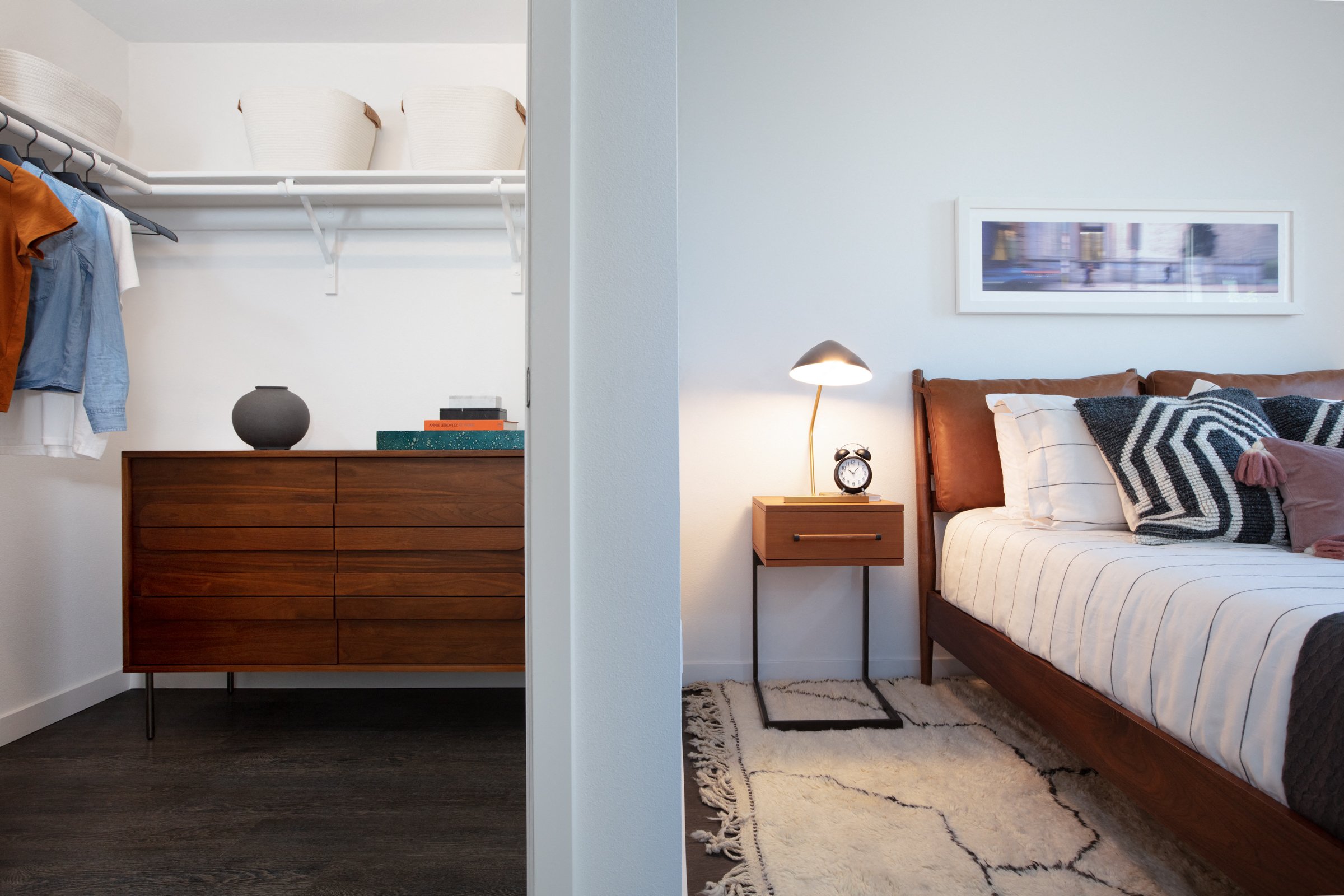 a bedroom with a bed and a dresser and a closet