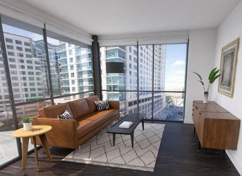 a living room with a large window and a couch and a table
