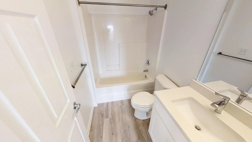 a bathroom with a toilet and a sink and a bath tub
