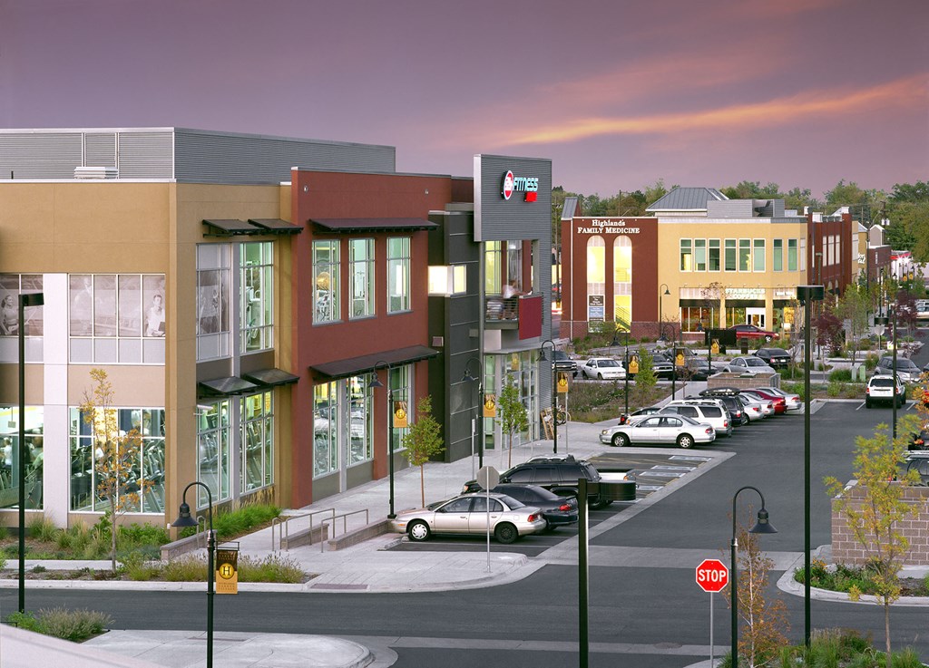 an aerial view of a city street with cars and buildings