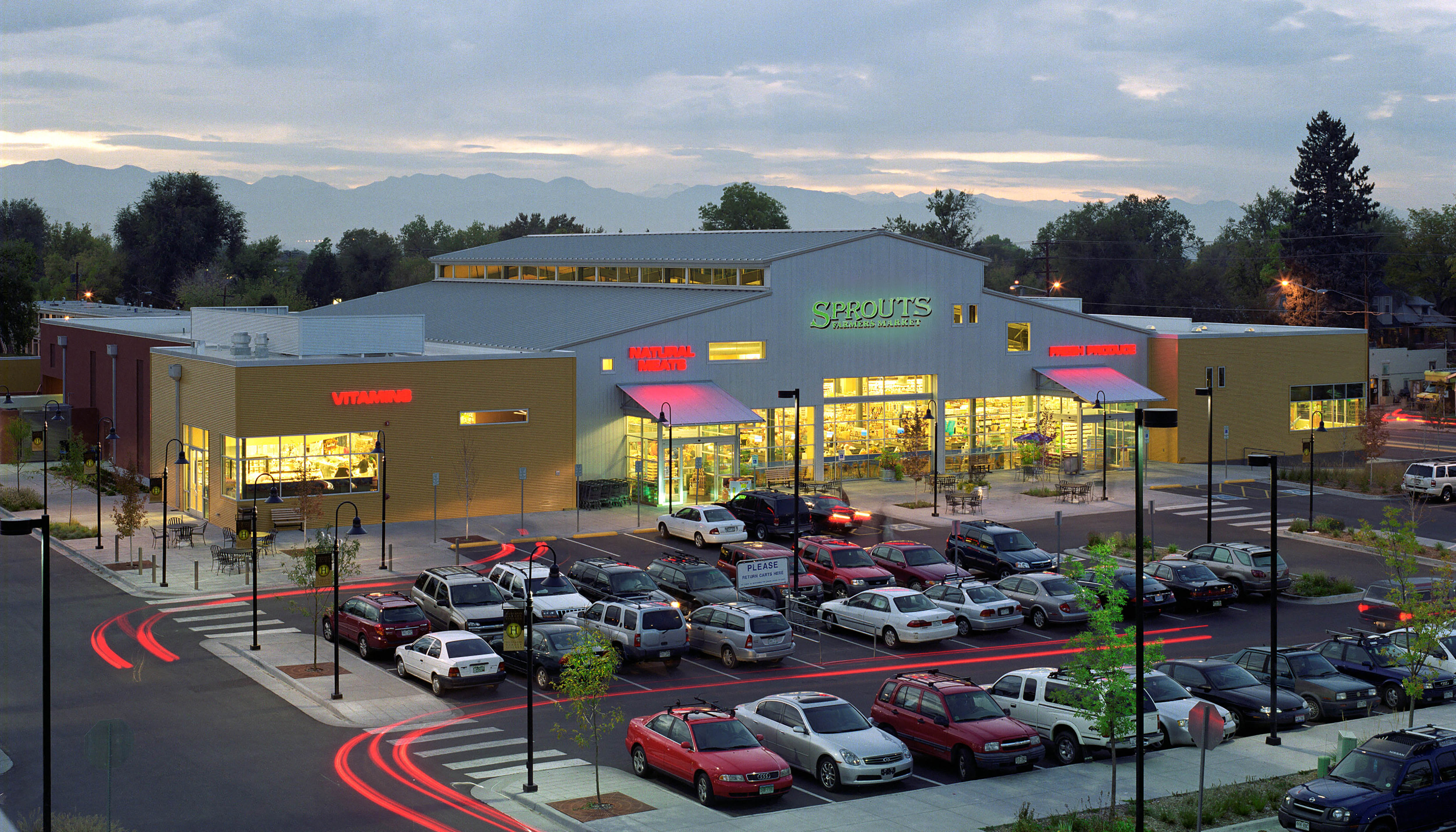 a parking lot full of cars in front of a grocery store
