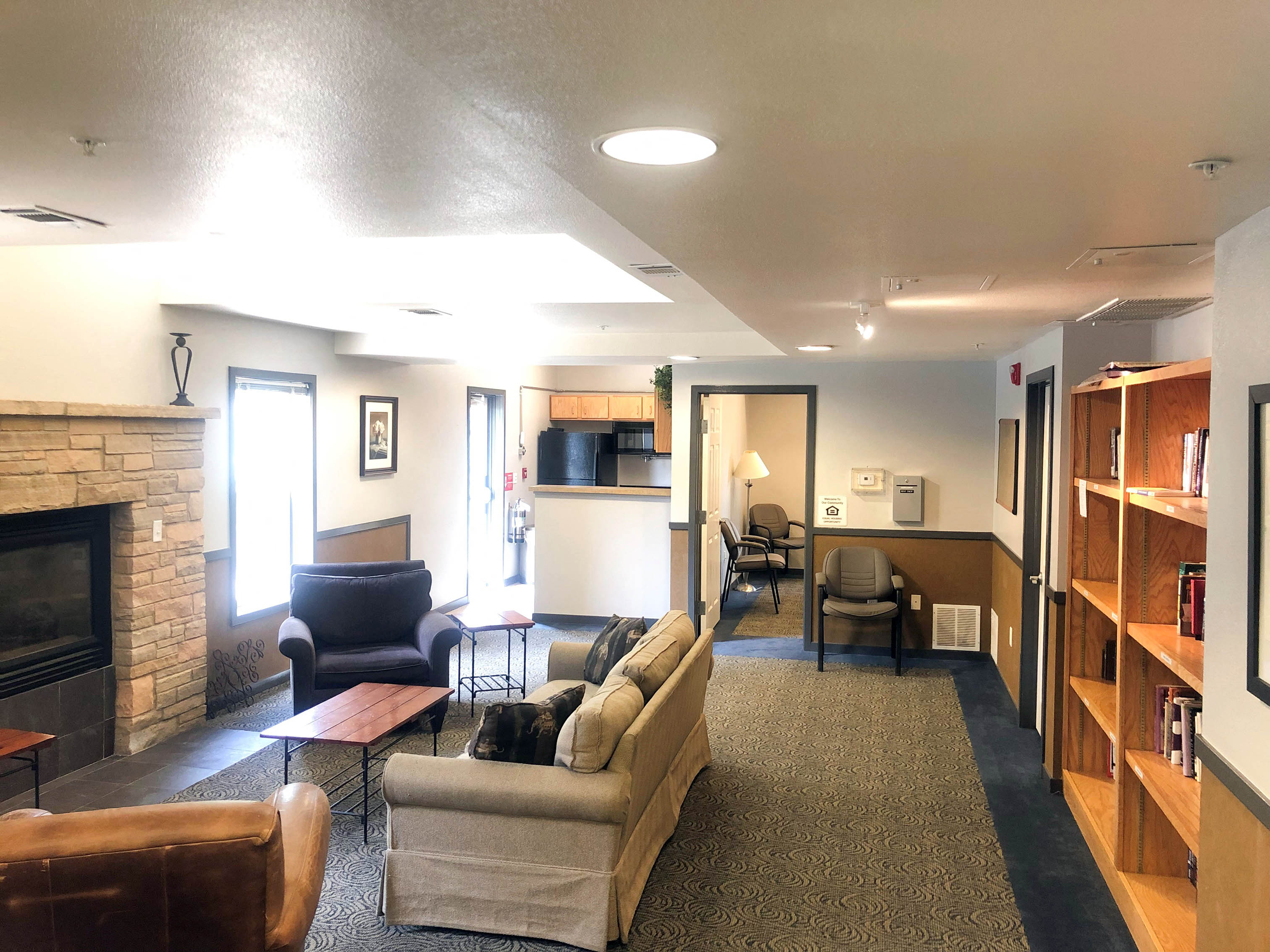 a living room with couches and chairs and a fireplace