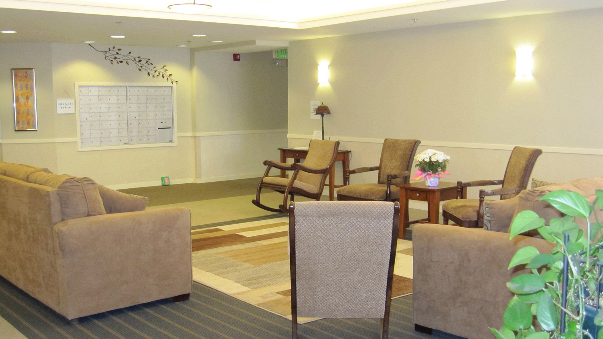 a living room with couches and chairs and a table