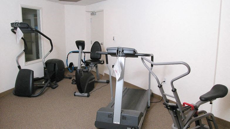 a group of exercise machines in a room