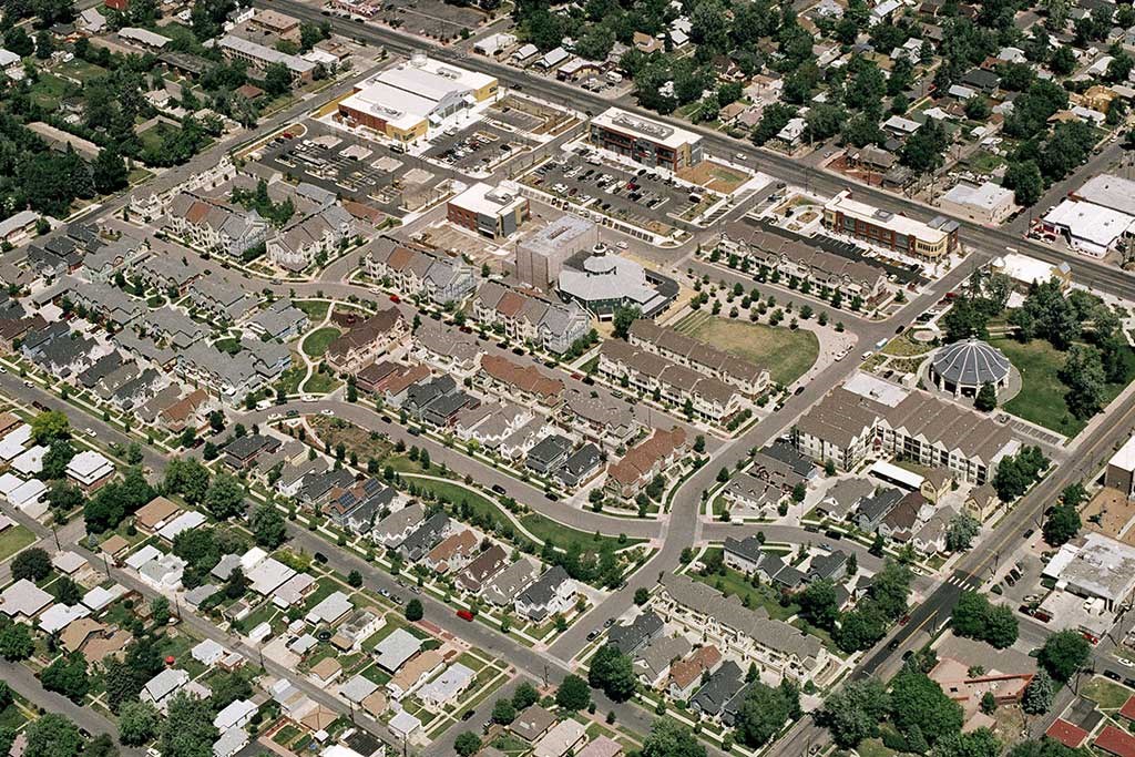 an aerial view of a city with lots of houses and roads
