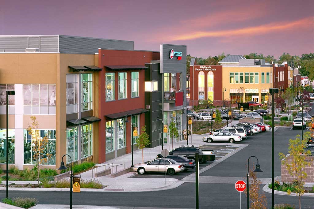a city street with cars parked in front of buildings
