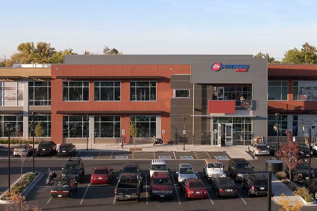 a parking lot full of cars in front of a building