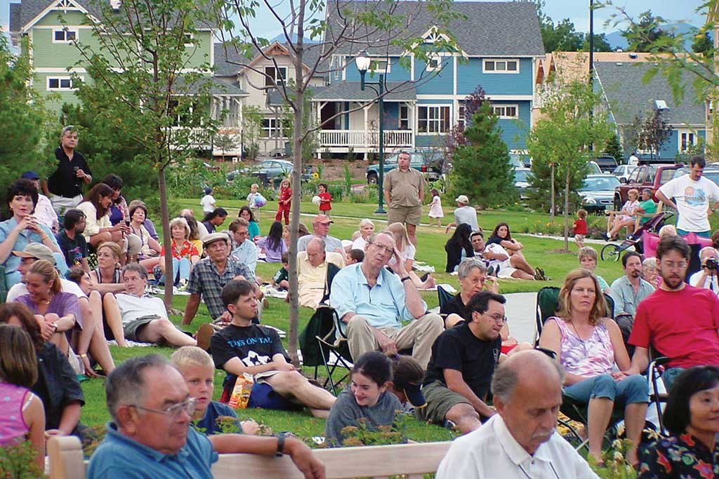 a crowd of people sitting in a park
