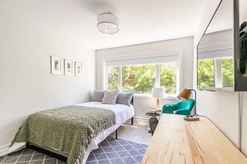 a bedroom with a bed and a window