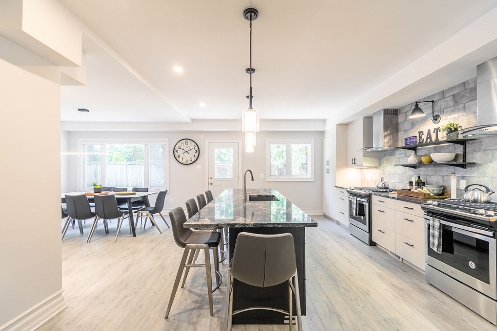 a kitchen with a large island and a table with chairs