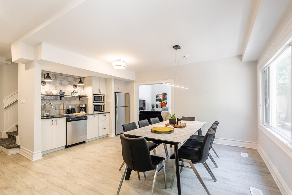 a dining room with a table and chairs and a kitchen