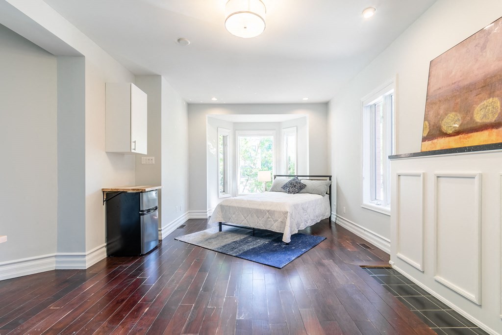 a bedroom with a bed and a window