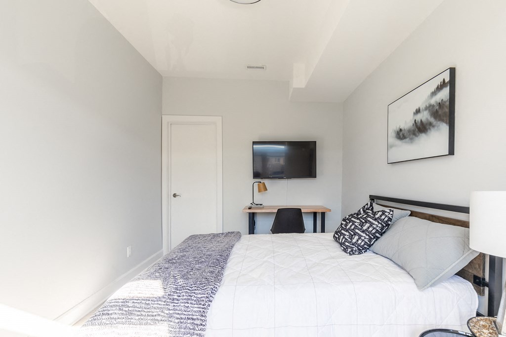 a bedroom with a bed and a tv in it