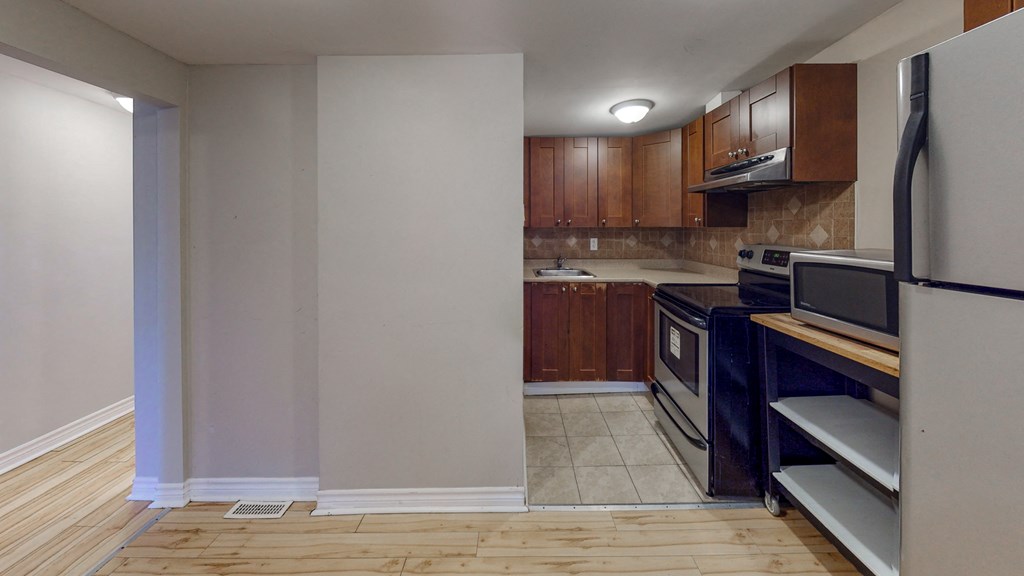 a kitchen with black appliances and wooden cabinets