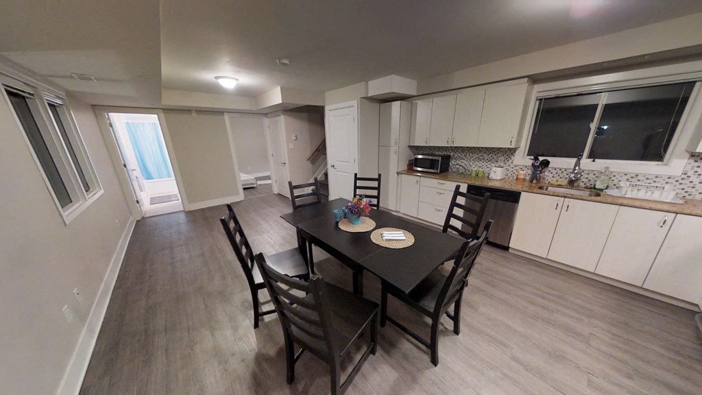 a dining room and kitchen with a table and chairs