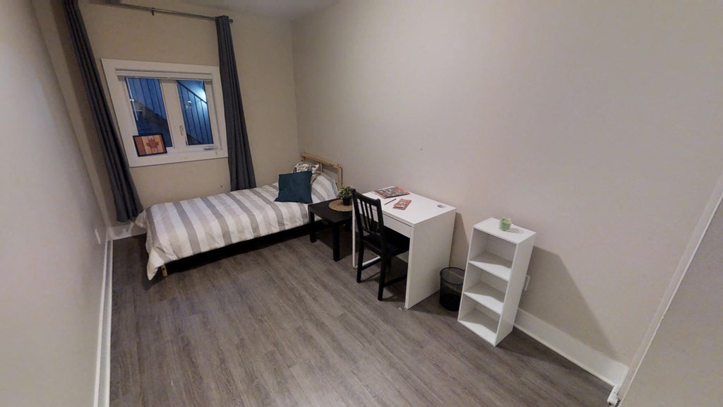 a small room with a desk and a bed