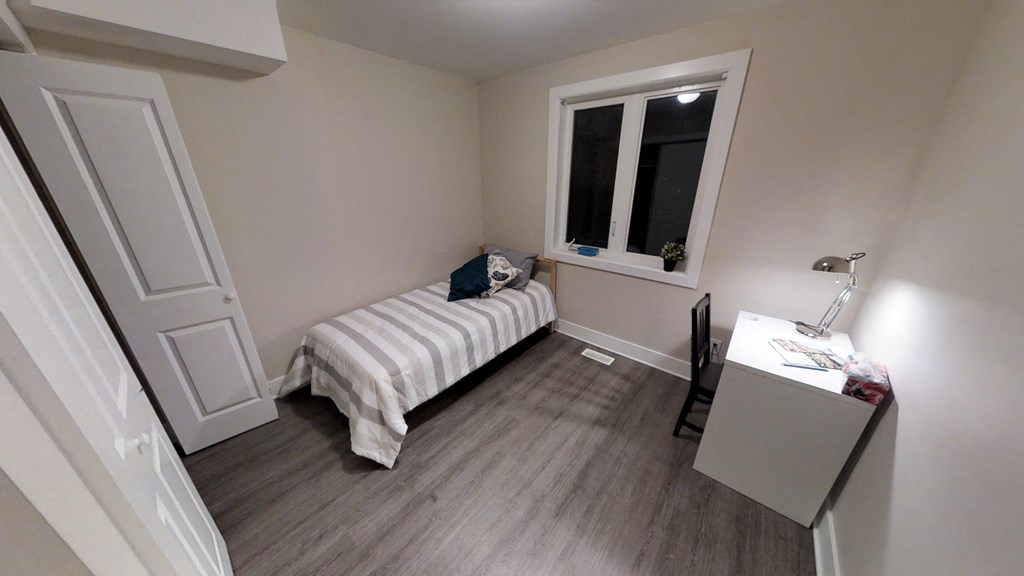 a small bedroom with a bed and a window