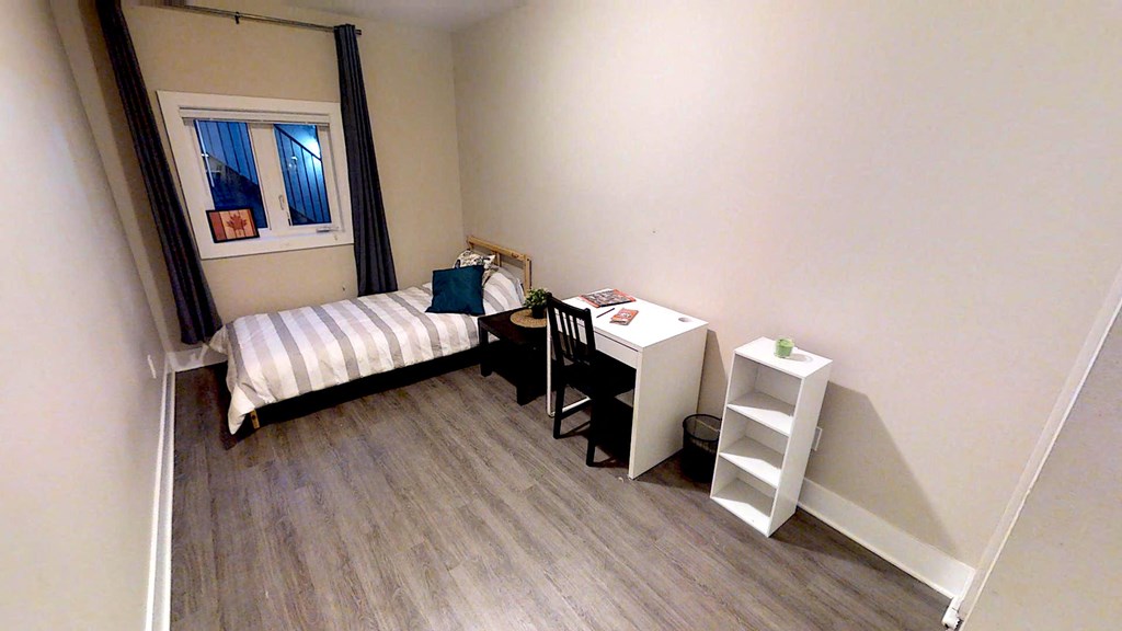 a small room with a desk and a bed