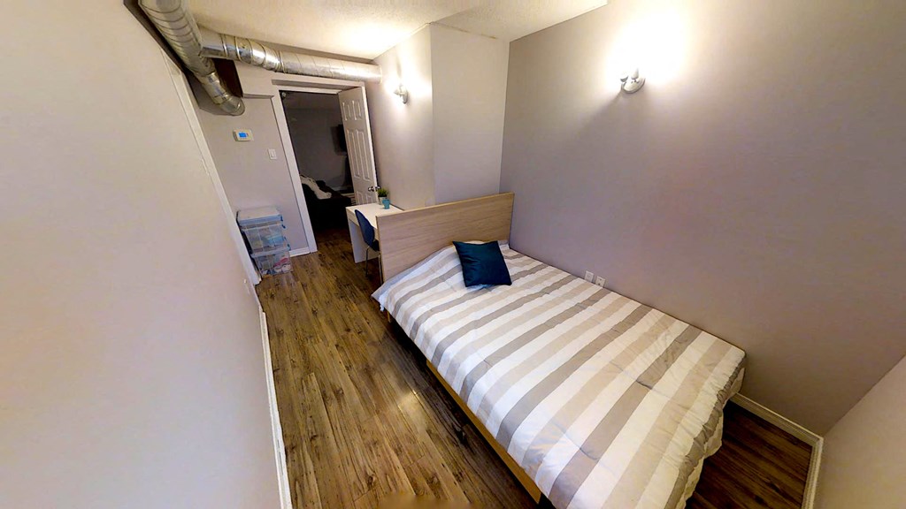 a bedroom with a bed in a small room