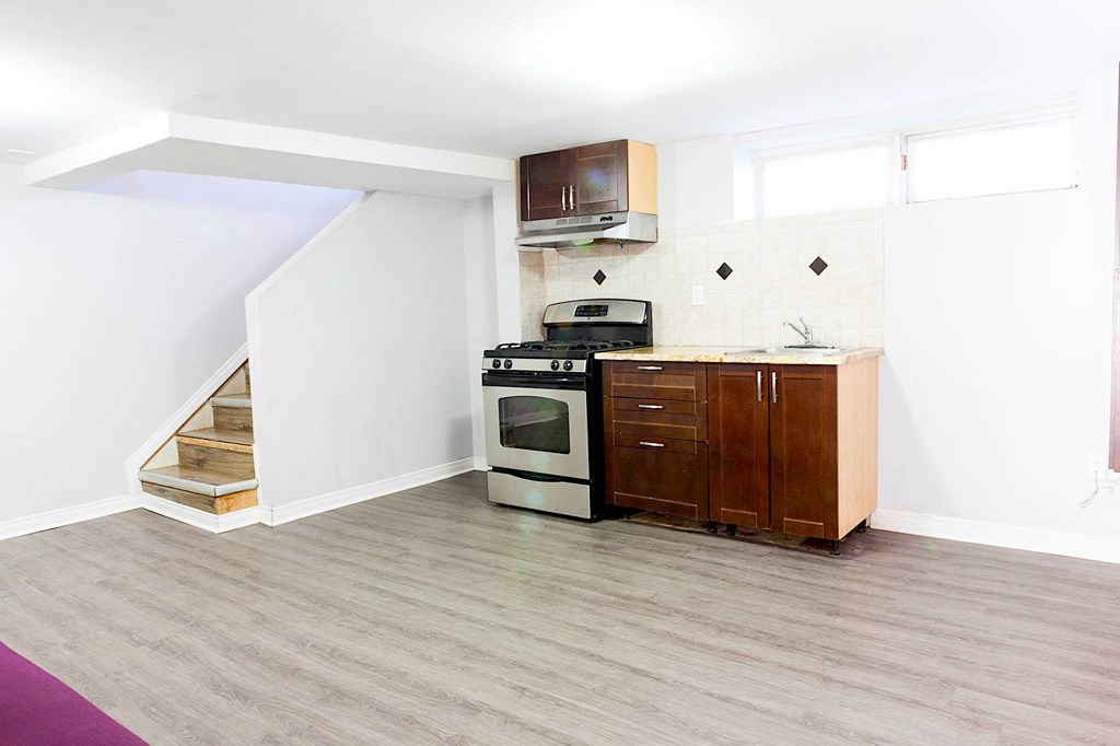 an empty kitchen with a stove and a sink