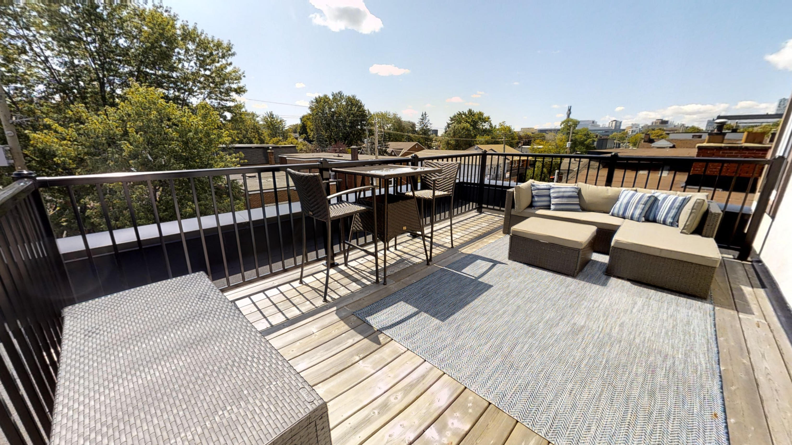 a large deck with furniture and a table on it