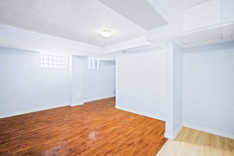 an empty room with blue walls and a wood floor